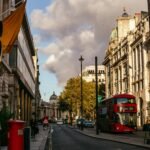 Street view in London with offices and transport, symbolizing UK businesses adopting cloud-based telephone systems for international calls